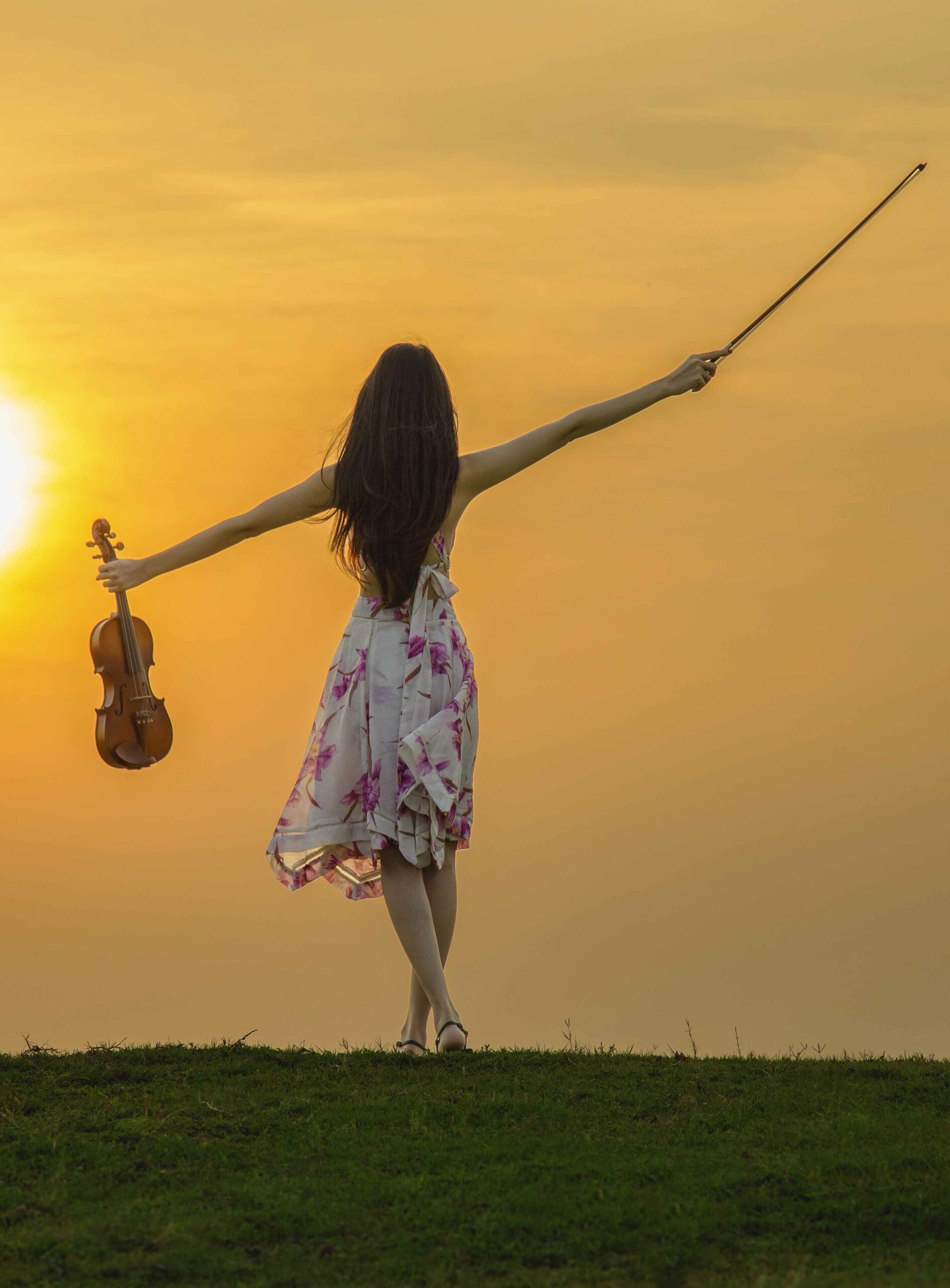 Beautiful woman enjoying music at sunset